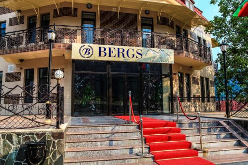 a building with a red carpet in front of a store at Bergs Hotel And Restaurant in Qax
