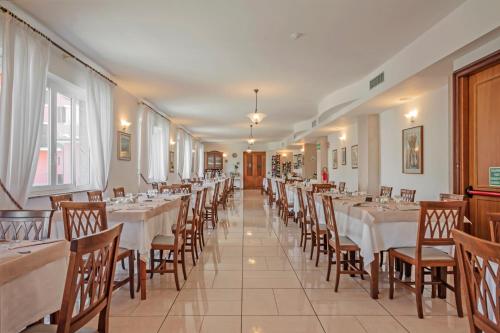a row of tables and chairs in a restaurant at Albergo Rondò in Acqui Terme