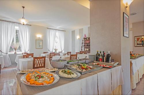 a table with several plates of food on it at Albergo Rondò in Acqui Terme
