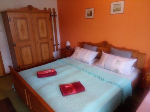 a bedroom with two beds with red candles on them at Pension Waldblick in Spiegelau