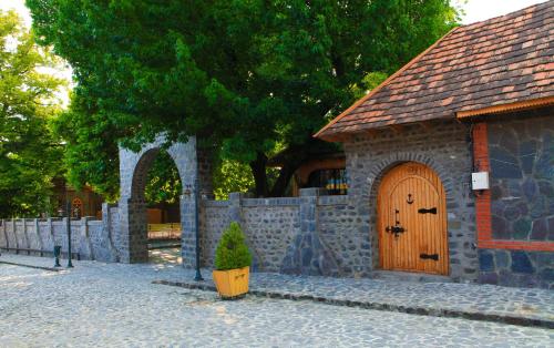 a small building with a wooden door on a street at Bergs Hotel And Restaurant in Qax