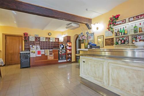 a bar in a restaurant with a counter at Albergo Rondò in Acqui Terme