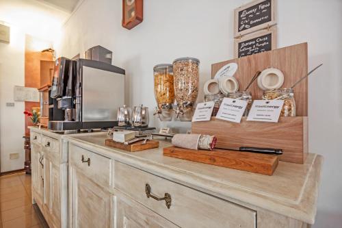 a kitchen with a counter with a coffee maker and a microwave at Albergo Rondò in Acqui Terme