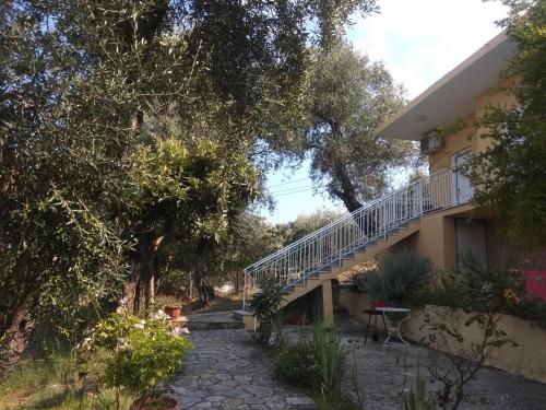 a house with a staircase leading up to it at Barbara's Sea View Home in Benitses