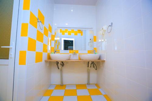 a bathroom with two sinks and a mirror at Art Samarqand in Samarkand