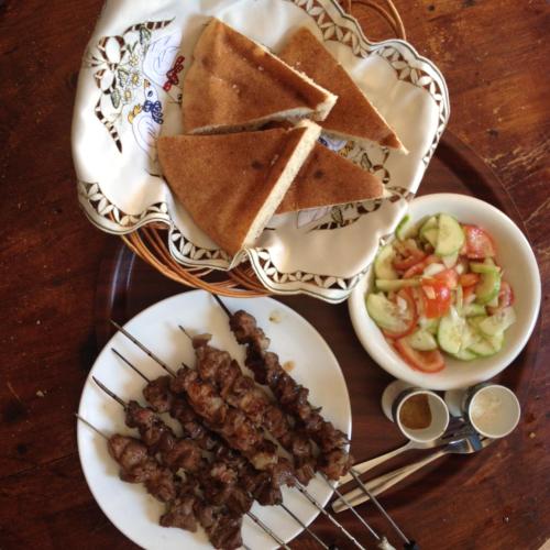a table with plates of food and a bowl of salad at Ferme D"Hote Lala Fatima in Aïn Leuh