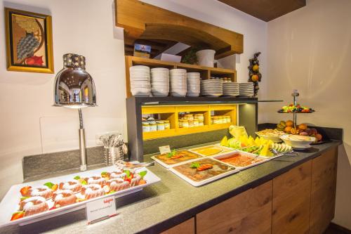 a buffet line with many different types of food at Hotel Babymio in Kirchdorf in Tirol