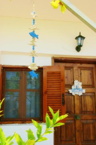 a house with a chandelier in front of a door at Platanos Apartment in Nea Moudania
