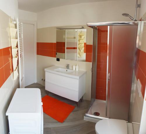 a bathroom with a white sink and a shower at Palmira Guest House in Aosta