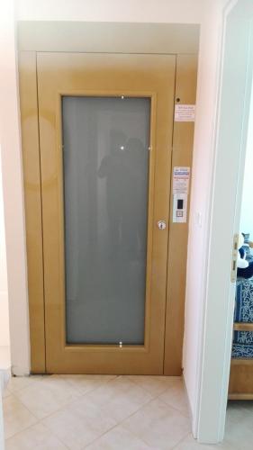 a glass door in a room with a door at LULA 'S HOUSE in Iraklitsa