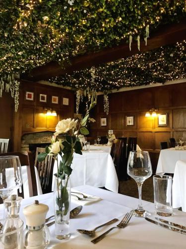 a table with a vase of flowers on a table at The Lion Hotel in Buckden