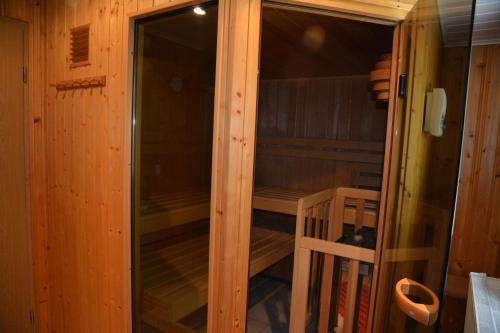 a sauna in a wooden cabin with a glass door at Gasthof Thomas Müntzer in Steinheid