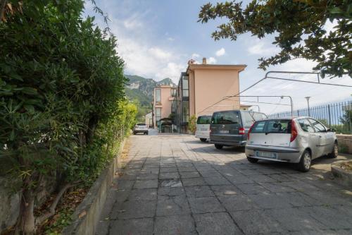 a group of cars parked on the side of a street at Hotel Lido in Gargnano