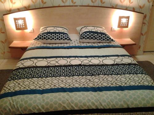 a bedroom with a large bed with two pillows at gîte vacances in Moncontour