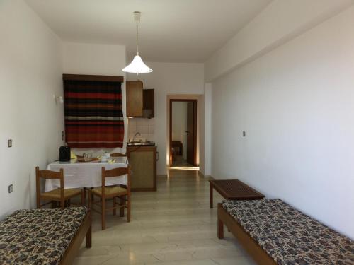 a room with a kitchen and a table and chairs at Anthoula Sunrise in Kokkíni Khánion