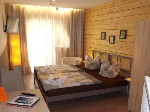 a bedroom with a bed with a wooden wall at Haus Oberkassel in Bonn