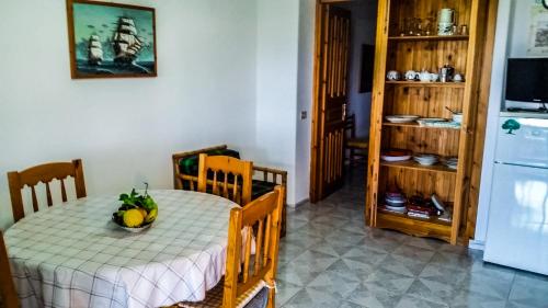 a kitchen with a table with a bowl of bananas on it at Appartamenti Luongo in Ischia