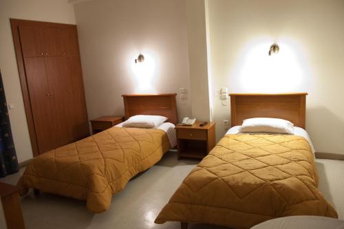 a hotel room with two beds in a room at Hotel Liberty in Mesolongion