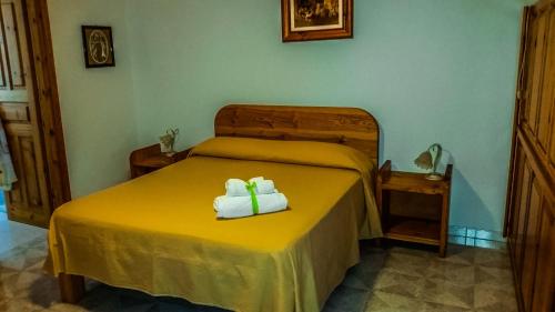 a bedroom with a bed with two towels on it at Appartamenti Luongo in Ischia