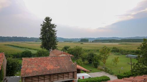 a view of a farm with a house and a field at Spighe Paglia e Girasole in Candia Canavese