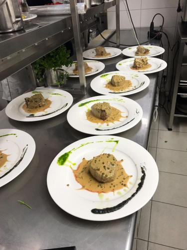 a row of white plates with food on a counter at ZUM BAHNHÖFLE Restaurant & Hotel - Albbruck Am Rhein in Albbruck