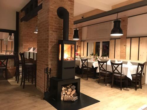 a fireplace in a dining room with a table at ZUM BAHNHÖFLE Restaurant & Hotel - Albbruck Am Rhein in Albbruck