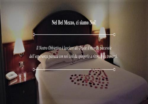 a bedroom with a bed with a heart on it at Venice Palace Hotel in Mirano