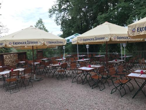 a group of tables and chairs with umbrellas at ZUM BAHNHÖFLE Restaurant & Hotel - Albbruck Am Rhein in Albbruck