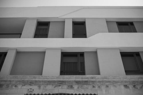 a black and white photo of a building with columns at Chapter 5 Hotel in Taʼ Xbiex