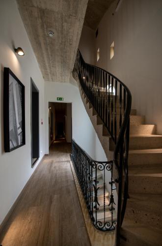 a spiral staircase in a building with a stair case at Chapter 5 Hotel in Taʼ Xbiex