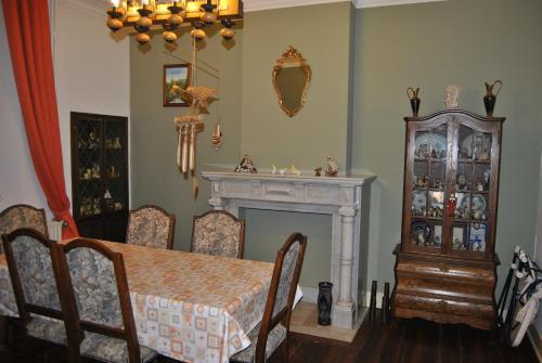 a dining room with a table and a fireplace at B&B La Place Verte in Surice
