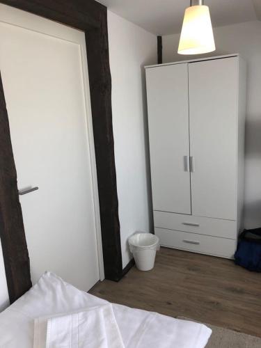 a bedroom with a bed and a closet and a mirror at ZUM BAHNHÖFLE Restaurant & Hotel - Albbruck Am Rhein in Albbruck