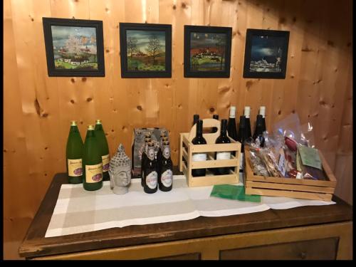 a table with a bunch of bottles of wine at Knottn Hüttl, St. Pankraz/Ulten, Nähe Meran in San Pancrazio dʼUltimo