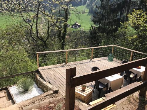 a wooden deck with a table and chairs on it at Knottn Hüttl, St. Pankraz/Ulten, Nähe Meran in San Pancrazio dʼUltimo