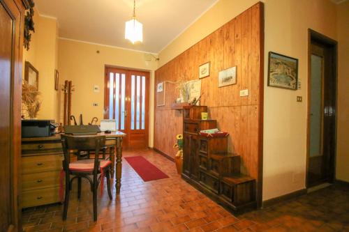 a kitchen with a table and a wooden wall at Spighe Paglia e Girasole in Candia Canavese