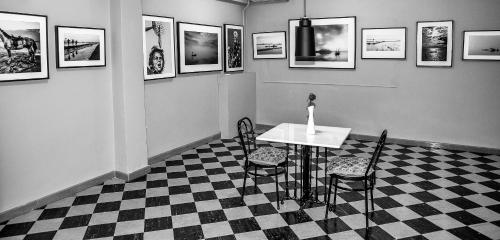 a room with a table and chairs and pictures on the wall at Hotel Liberty in Mesolongion