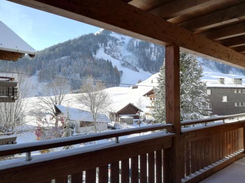 a view of a snowy mountain from a balcony at Appartements Sportsüberl in Berwang