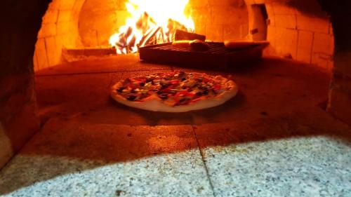 a pizza is in a brick oven at Camere de Inchiriat IGLOO in Predeal