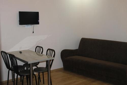 a living room with a table and a couch at mariko in Borjomi