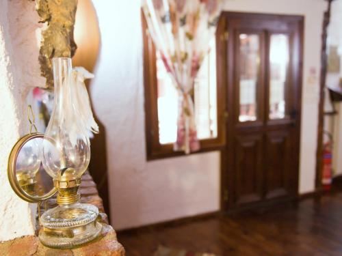 a glass vase sitting on a table next to a door at Guesthouse Xenios Zeus in Stavroupoli