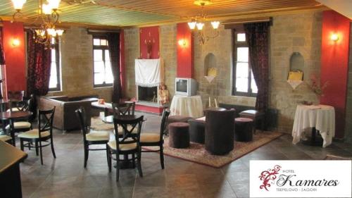 a restaurant with tables and chairs in a room at Hotel Kamares in Tsepelovo