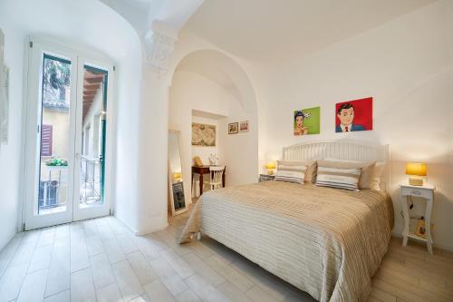 a bedroom with a large bed in a white room at Burò Bed & Relax in Parma