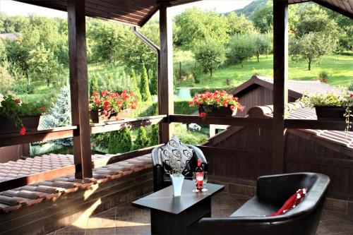a patio with two chairs and a table and a view at Silva House in Deva