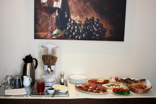 a table topped with plates of food and wine at Silva House in Deva