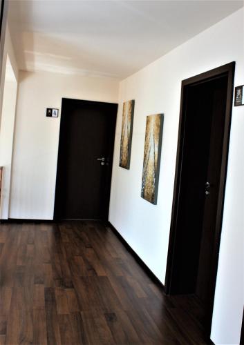 a room with two paintings on the wall and two doors at Silva House in Deva