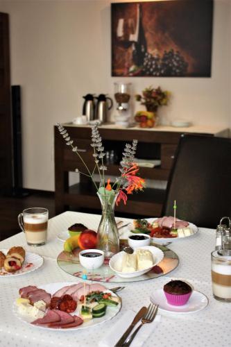 a table with plates of food on top of it at Silva House in Deva