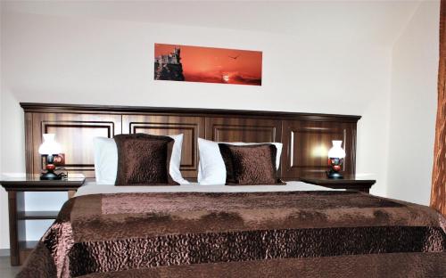 a bedroom with a large bed with two night stands at Silva House in Deva