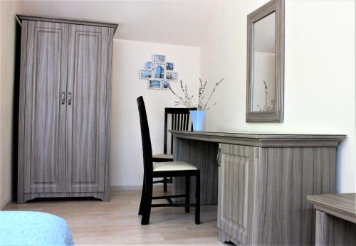 a bedroom with a desk and a mirror and a chair at Silva House in Deva