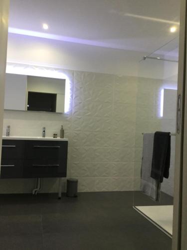 a bathroom with a sink and a mirror at Le Clos d 'Aÿ in Épernay