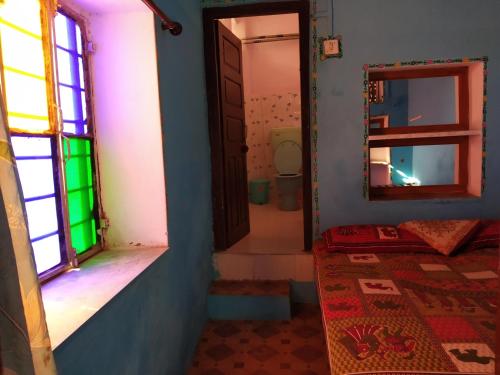 a room with a door and a mirror and a rug at Hotel Paramount Palace in Pushkar
